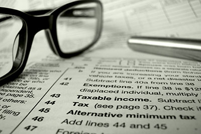 Tax and bookkeeping services - Glasses on paper